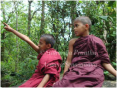 Young novice monks pointing out surrounding environment at the Sinharaja Cave Monastery